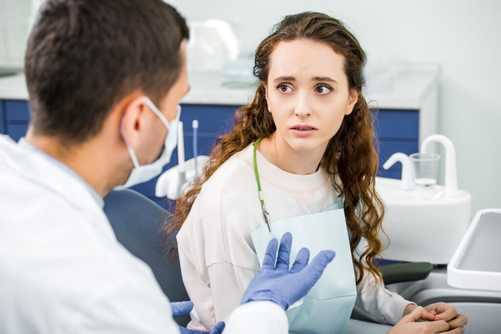 Dentist in Kenmore WA calmly talking with an anxious dental patient at Northshore Dental